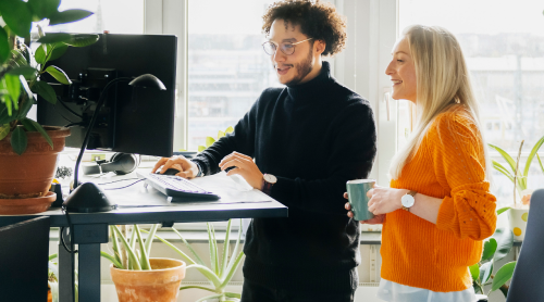 two coworkers looking at a computer